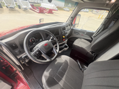 Peterbilt 579 truck cab interior showing steering wheel dashboard and driver seat.