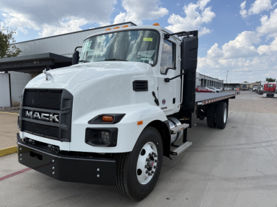 Mack MD6 flatbed truck showing front grille with MACK branding, large headlights, and side steps; white cab with black bumper and extended flatbed.