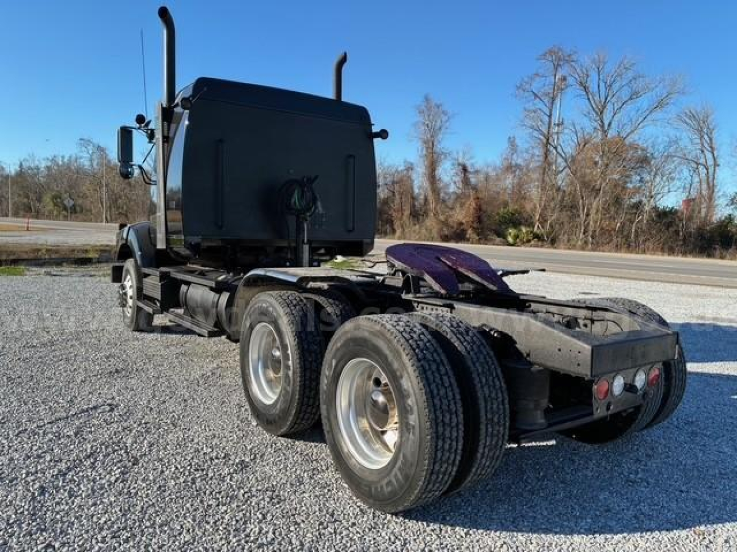 Western Star 4900 SA truck chassis rear view showing dual rear axles and fifth wheel.