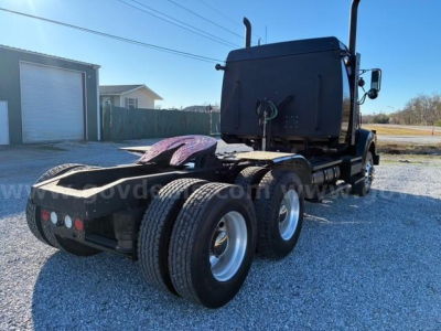 Western Star 4900 SA tractor rear view showing dual rear axles and fifth wheel.
