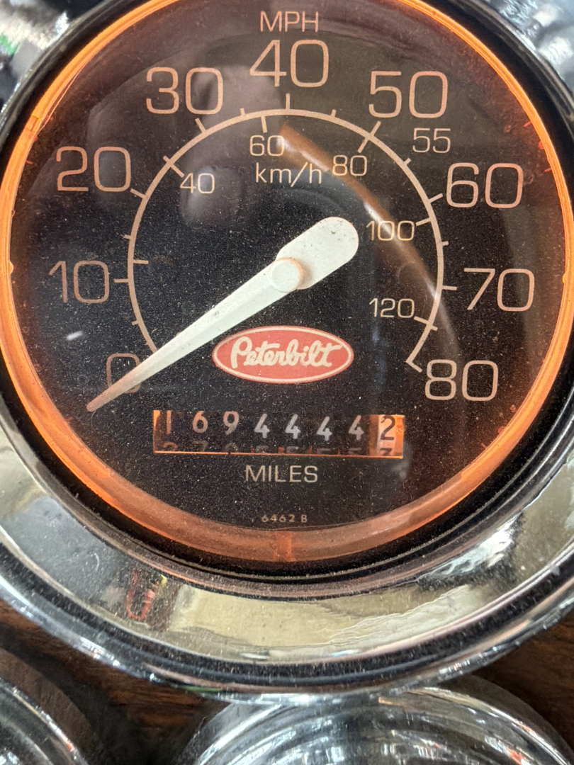 Peterbilt tachometer-style speedometer showing MPH up to 80 and KMH up to 120 with an odometer reading (about 69,444 miles).