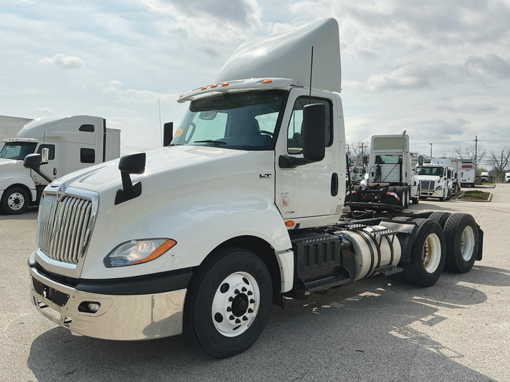 White 2019 International LT625 daycab tractor with cab and chassis, showing twin rear axles and front grille, side mirrors, and fuel tanks.