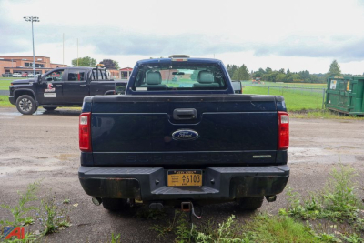 Ford F-350 Super Duty pickup rear view showing tailgate, bumper, and license plate in a parking lot.