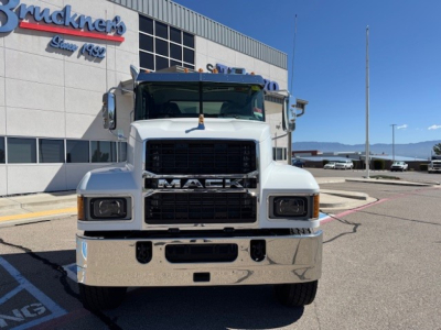 Mack PI64 dump truck front view showing large black grille and chrome bumper with Mack lettering.