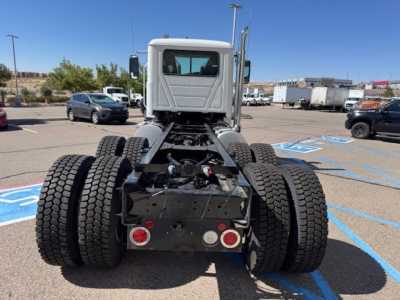 Mack PI64 truck rear view showing dual rear axle configuration, tires, chassis, and cab; no surrounding labels readable.