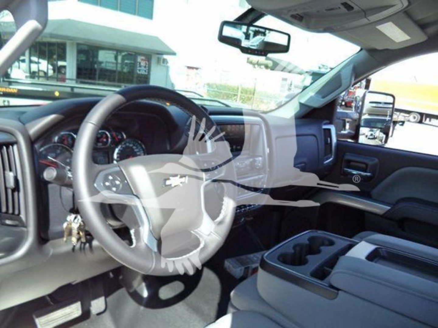 Chevrolet Silverado 6500HD truck interior showing steering wheel and dashboard with center console and cupholders
