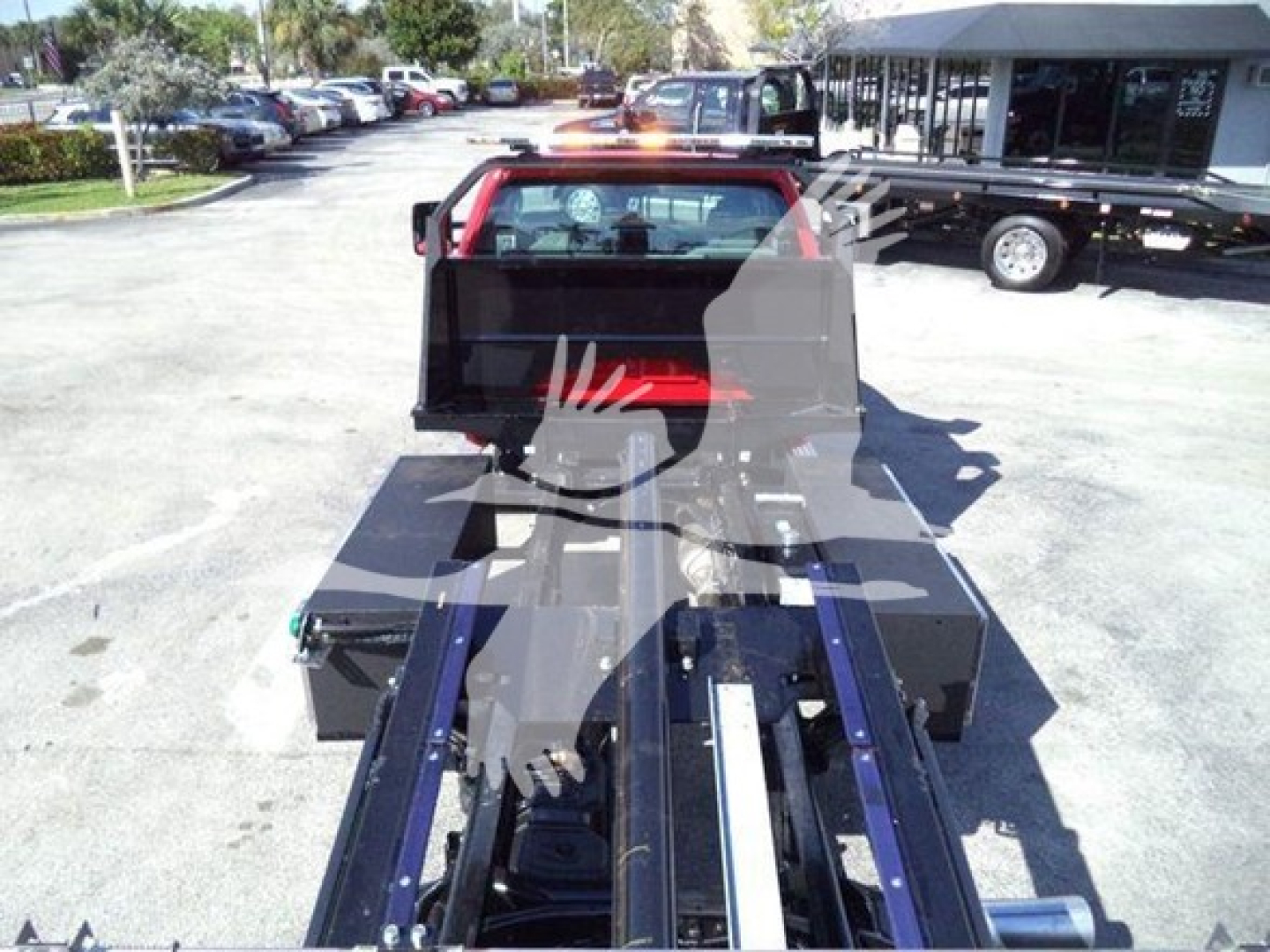 Chevrolet Silverado 6500HD rollback truck chassis and bed with hydraulic tow apparatus in view.