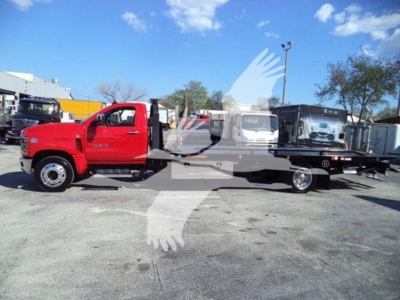 Chevrolet Silverado 6500HD rollback truck in red cab and black rollback bed, side view with flatbed and tow equipment