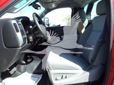 Interior of a 2023 Chevrolet Silverado 6500HD cab showing driver seat, steering wheel, and front passenger seat with gray upholstery.