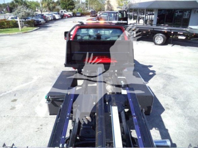 Chevrolet Silverado 6500HD rollback truck chassis and bed with hydraulic tow apparatus in view.