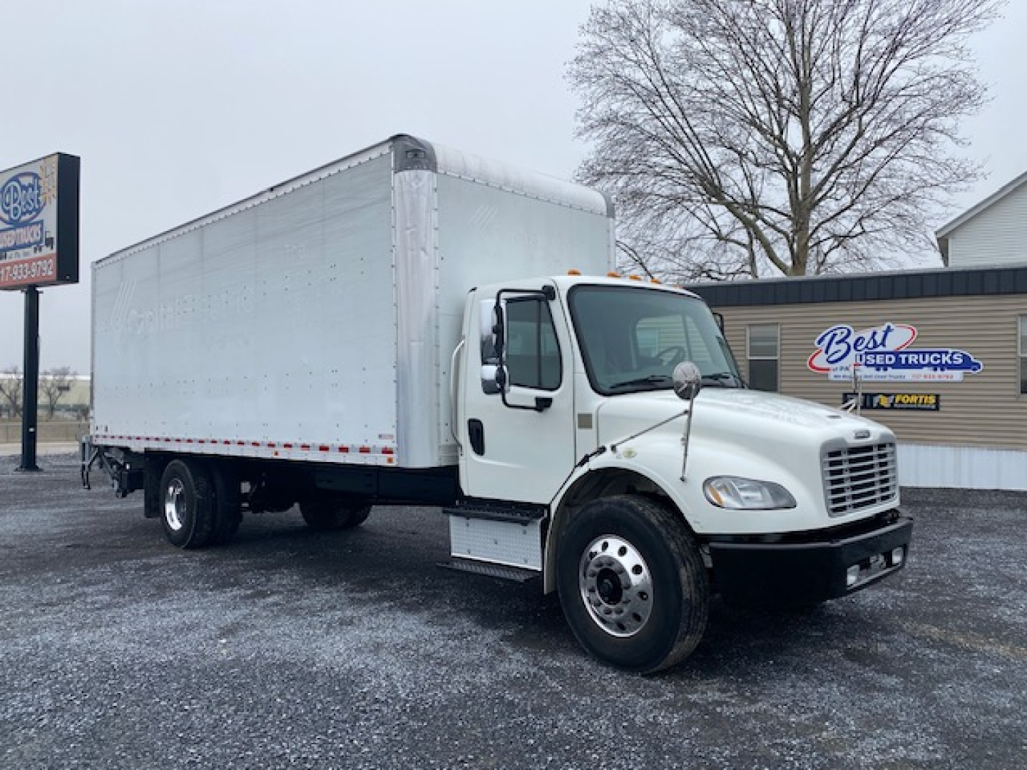 Freightliner M2-106 box truck viewed from front-right showing cab and long box cargo area