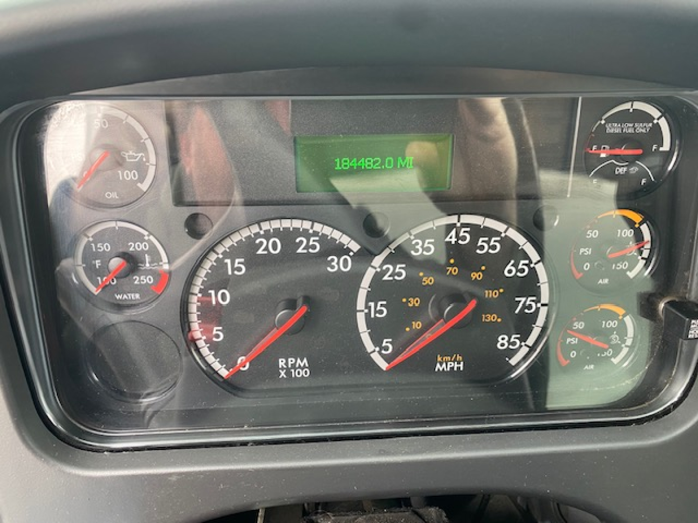 Dashboard of a 2019 Freightliner M2-106 showing gauges and digital odometer reading 184,482.0 miles in green display.