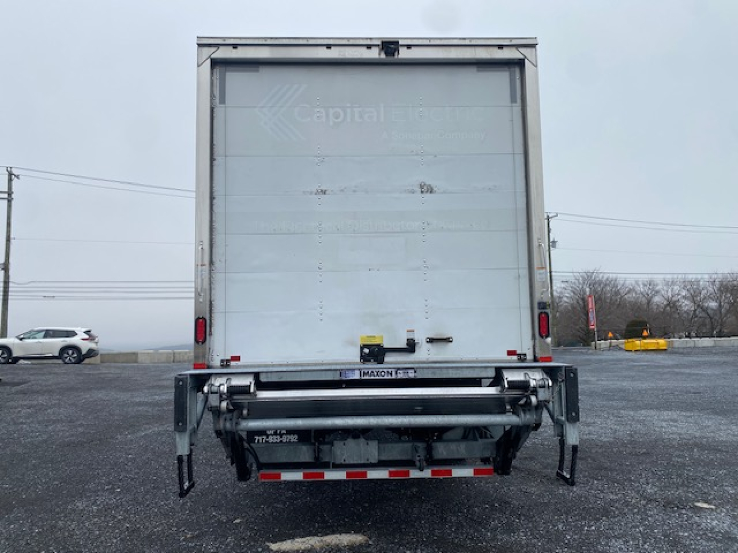 Freightliner M2-106 rear view showing box trailer with tailgate and rear underride guard.