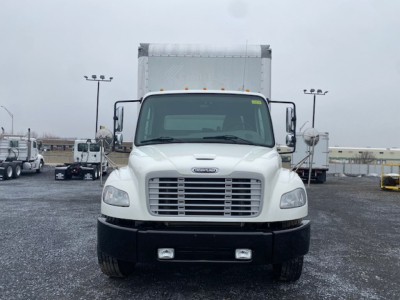 Front view of a white 2019 Freightliner M2-106 truck in a lot, with large grille, rectangular headlights, and box body behind cab.