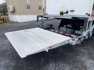 Freightliner M2-106 rear with collapsible aluminum lift gate extended and platform visible.