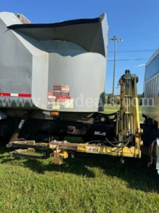 Dump truck bed and hydraulic hitch of a 2013 Freightliner M2 with rear view showing dump hopper and mounting frame.