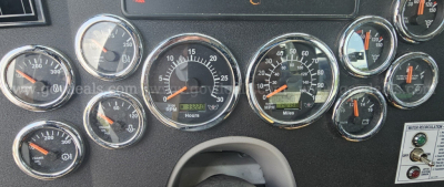 Dashboard cluster of a Western Star truck showing multiple gauges including RPM, speed, and engine indicators.