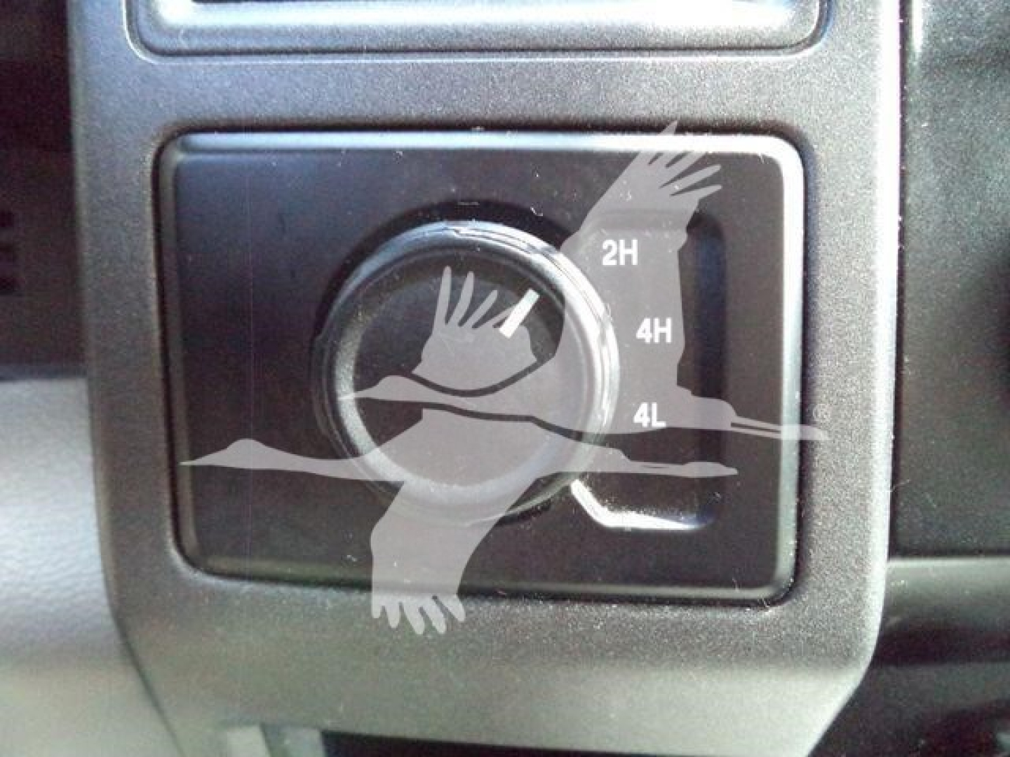 Ford F-550 dashboard control with four-wheel drive selector set to 4H, 2H markings visible.
