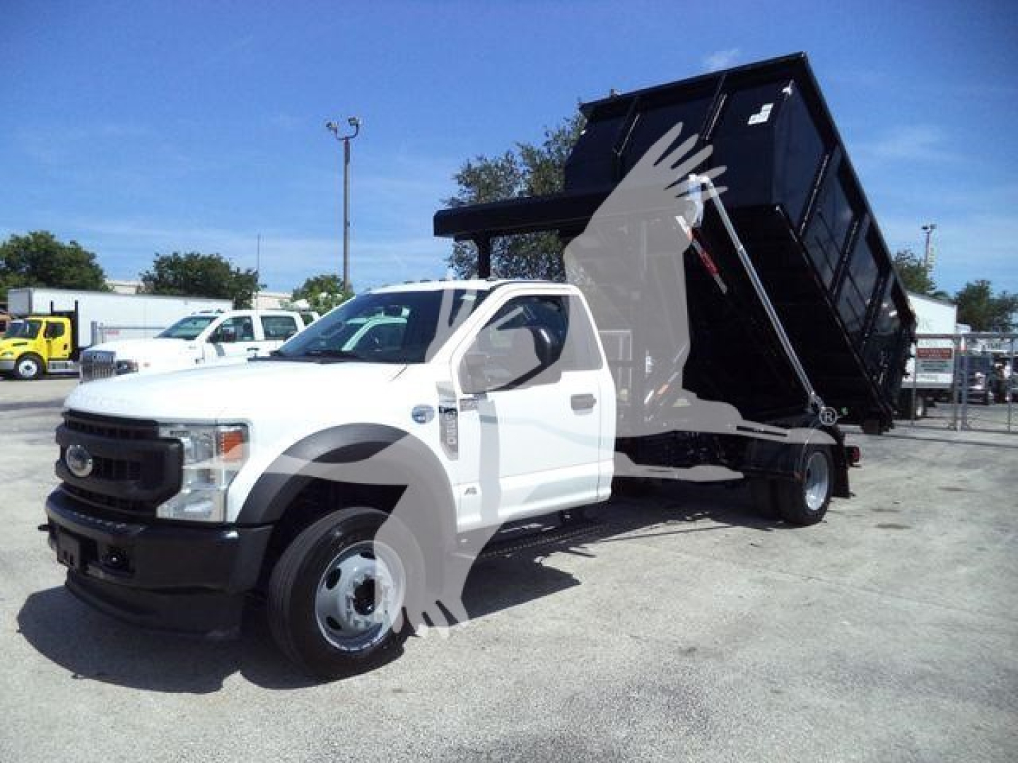 Ford F-Series dump truck in-service showing dump bed raised on hydraulic cylinders