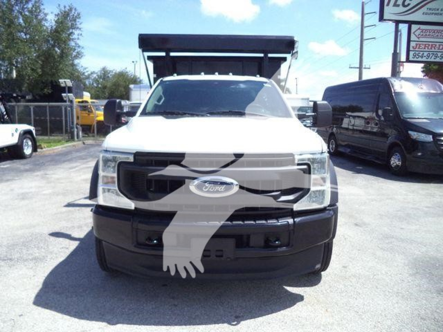 Front view of a white 2020 Ford F-550 roll-off truck showing front grille and bumper.