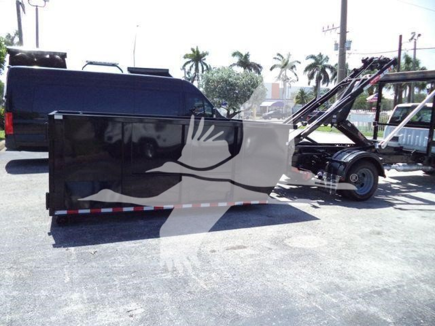 2020 Ford F550 rolloff truck with black cab and attached lifting mechanism, side view showing stock number and category text overlay.
