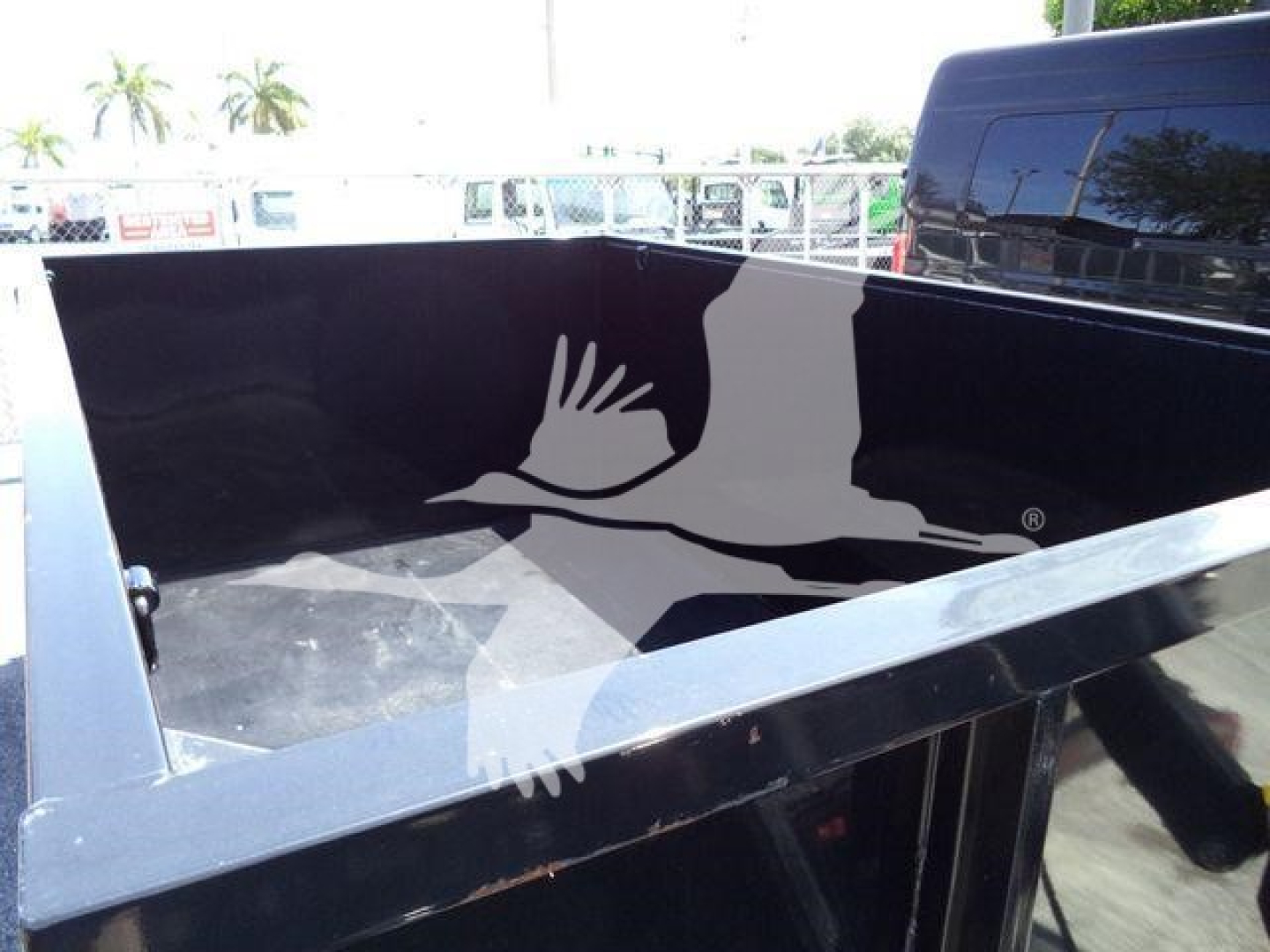 Ford F-550 truck bed showing inner cargo area of black dump with no contents.
