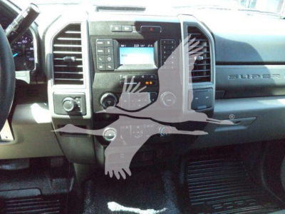 Dashboard and center console of a 2020 Ford F-550 pickup truck, showing radio, climate controls, and steering area.