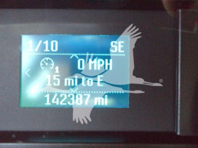 Ford F550 dashboard display showing 0 MPH, 15 mi to E, 142387 mi odometer, SE display, 1/10, with graphic overlay