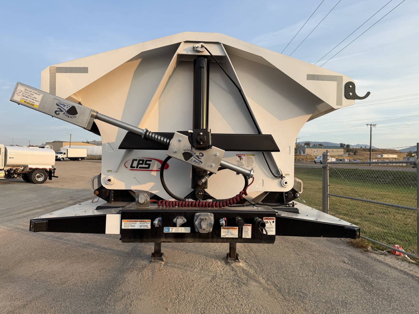 Manac 42' tri-axle dump trailer rear view showing hydraulic power unit and control lever with CPS label.