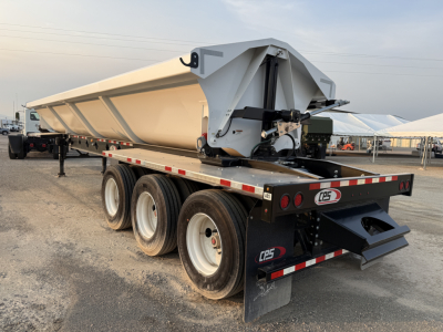 Manac 42' tri-axle dump trailer in view showing side and rear, white/tan body, dual rear gates, triple axle with heavy tires, NAS tag CPS branding, parked lot.
