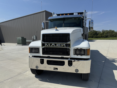 Front view of a 2026 Mack PI64 dump truck showing bold MACK grille, large chrome bumper, dual mirrors, and headlights.