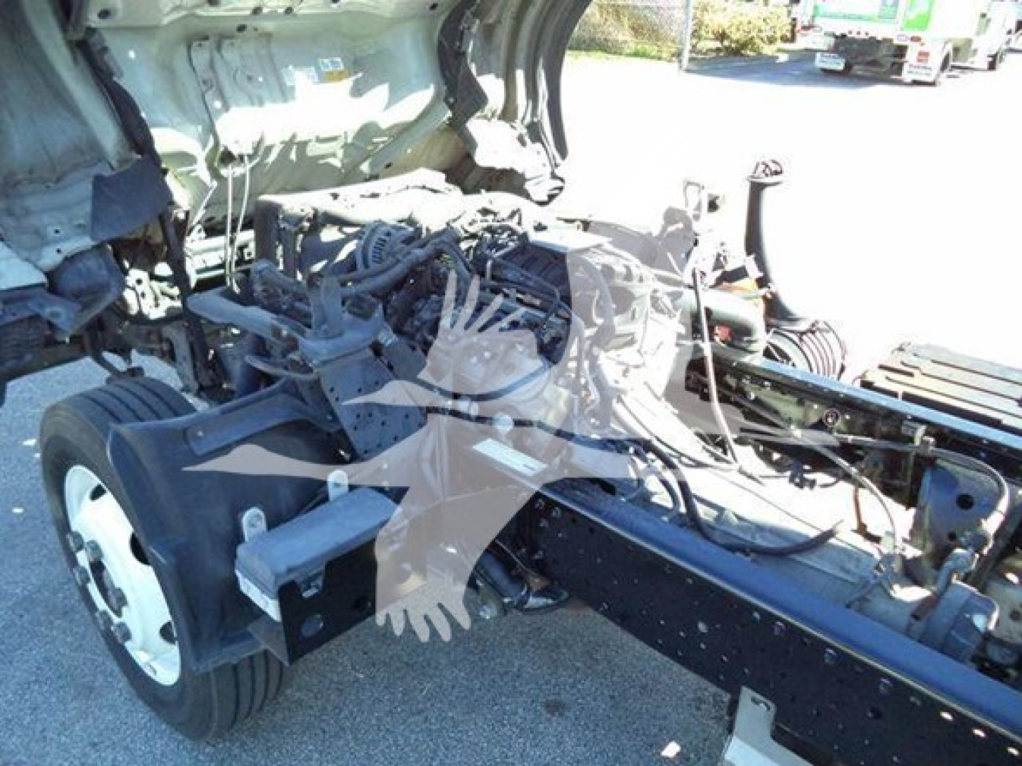 Isuzu NPR HD cab chassis showing engine bay and frame with exposed components.