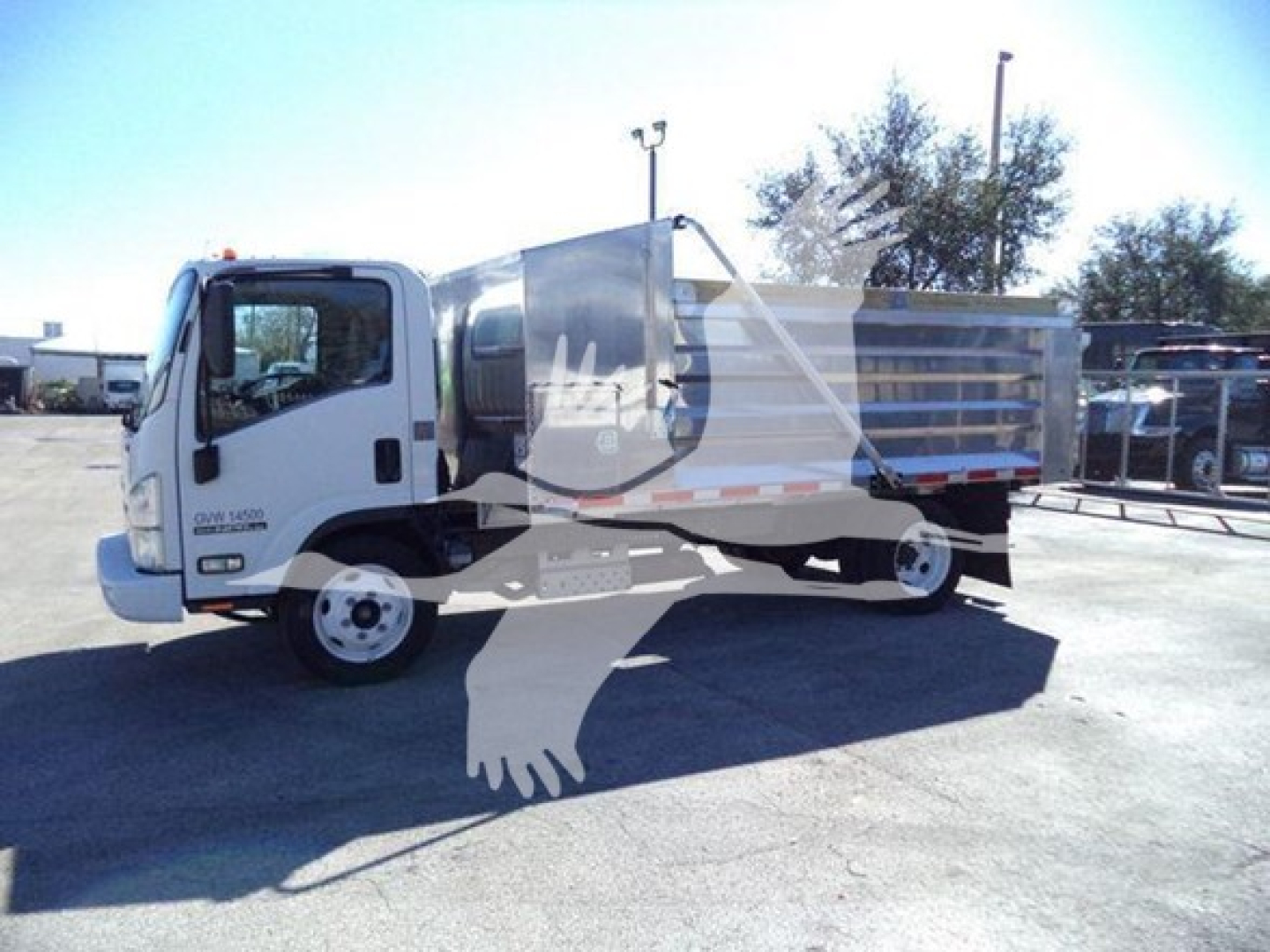 Isuzu NPR-HD dump truck in-service showing cab and dump body with metal panels; faint dealership watermark overlay across the image.