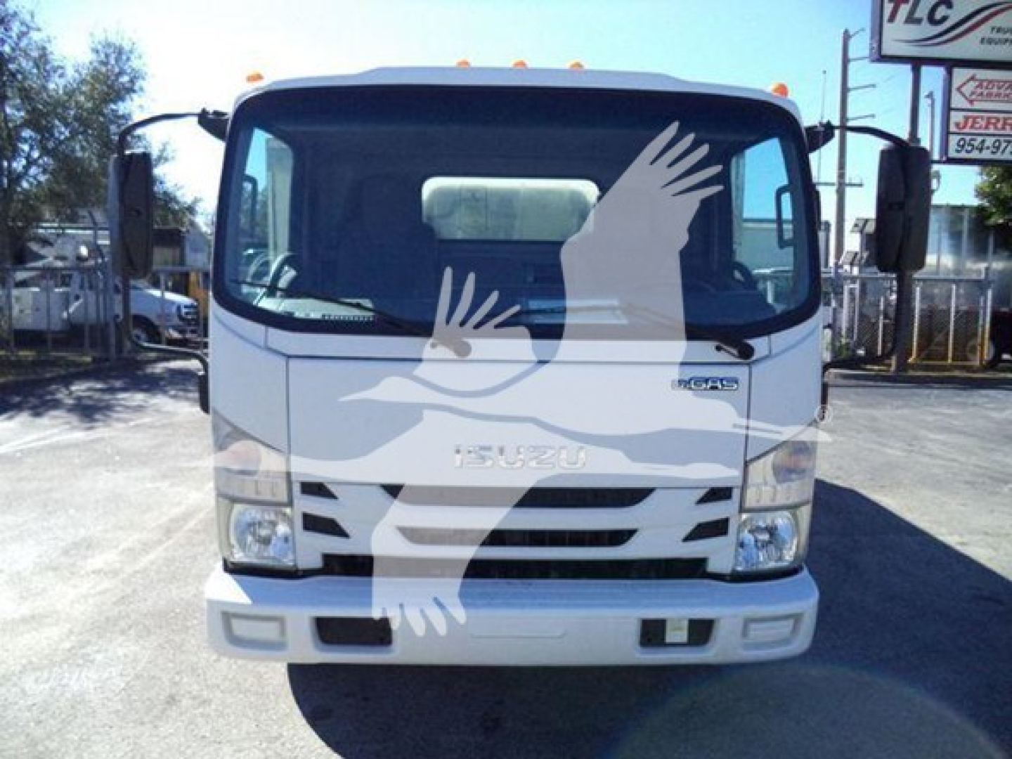 Isuzu NPR HD truck front view showing Isuzu emblem and grille; windshield with side mirrors; headlights; white bumper; no visible text aside from the truck design.