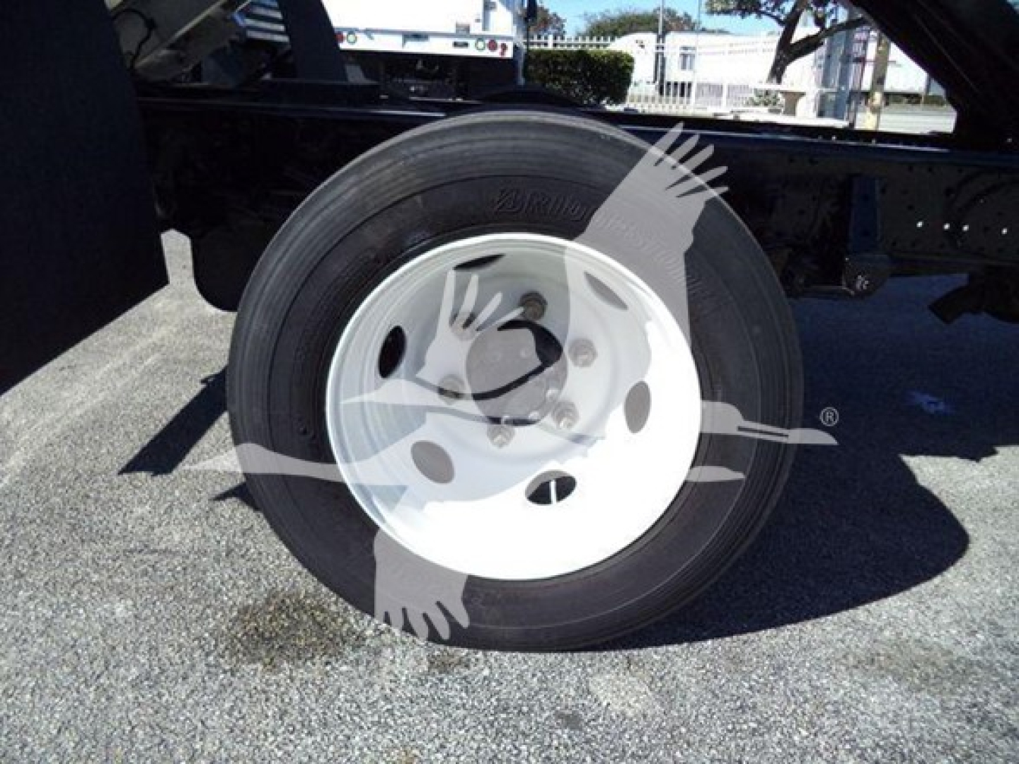 Isuzu NPR-HD wheel and tire visible on a truck chassis; no legible labels or text readable on the visible portion of the image aside from the wheel and tire.