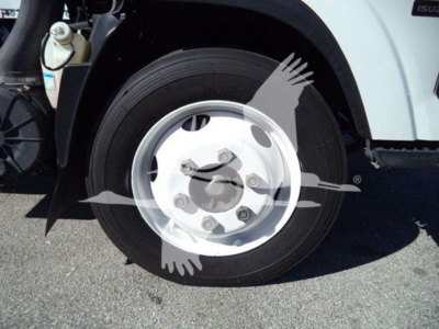 Isuzu NPR HD front wheel and tire with white steel rim and hub, part of truck chassis.