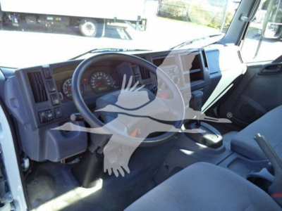 Isuzu NPR-HD truck interior cockpit with steering wheel and dashboard visible.