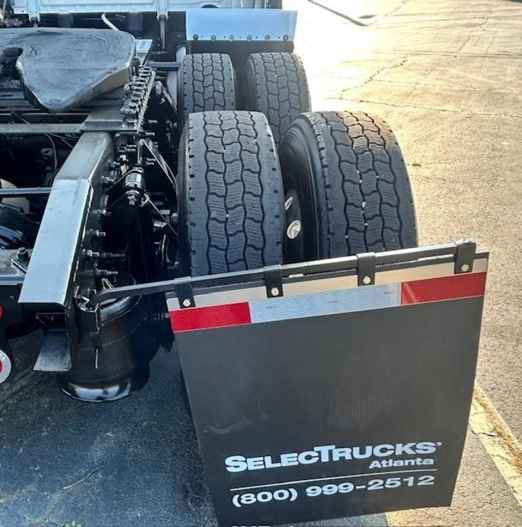 Freightliner Cascadia 126 rear chassis and dual rear axles showing tires and mudflap with SELECT TRUCKS Atlanta contact number.