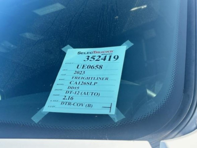 Sticker on windshield showing listing details: Stock 352419, UE0658, 2023 Freightliner CA126SLP, DD15, DT-12 (AUTO), 2/16, DTR-COV(B).