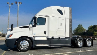 Truck tractor side view showing Freightliner Cascadia 126 sleeper cab with white exterior and chrome wheels.