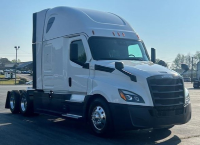 Freightliner Cascadia 126 sleeper cab truck side view showing white exterior, aerodynamic mirrors, dual rear axles, and black front grille.