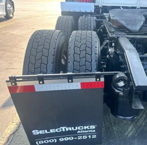 Freightliner Cascadia rear view showing dual rear axles and mudflap with SelectTrucks Atlanta contact information