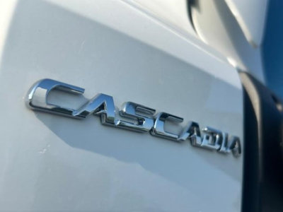 Freightliner Cascadia 126 badge on truck side showing CASCADIA chrome lettering.