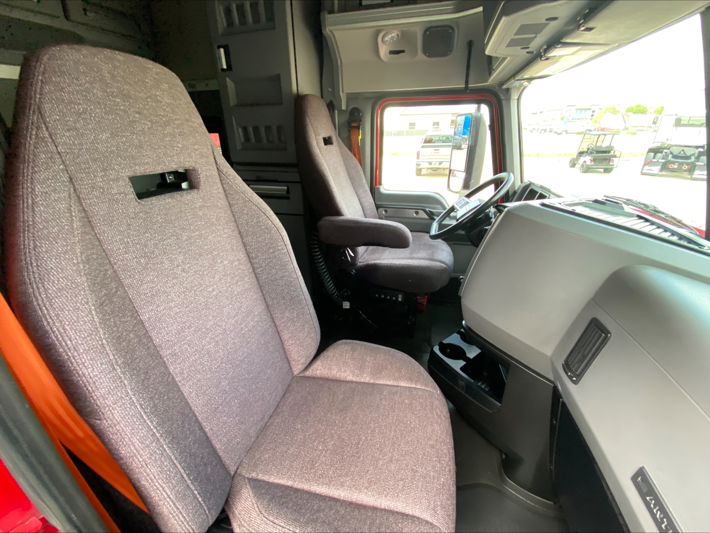 Cab interior of a 2020 Mack AN64T70 truck showing driver seat, passenger seat, and dashboard area.