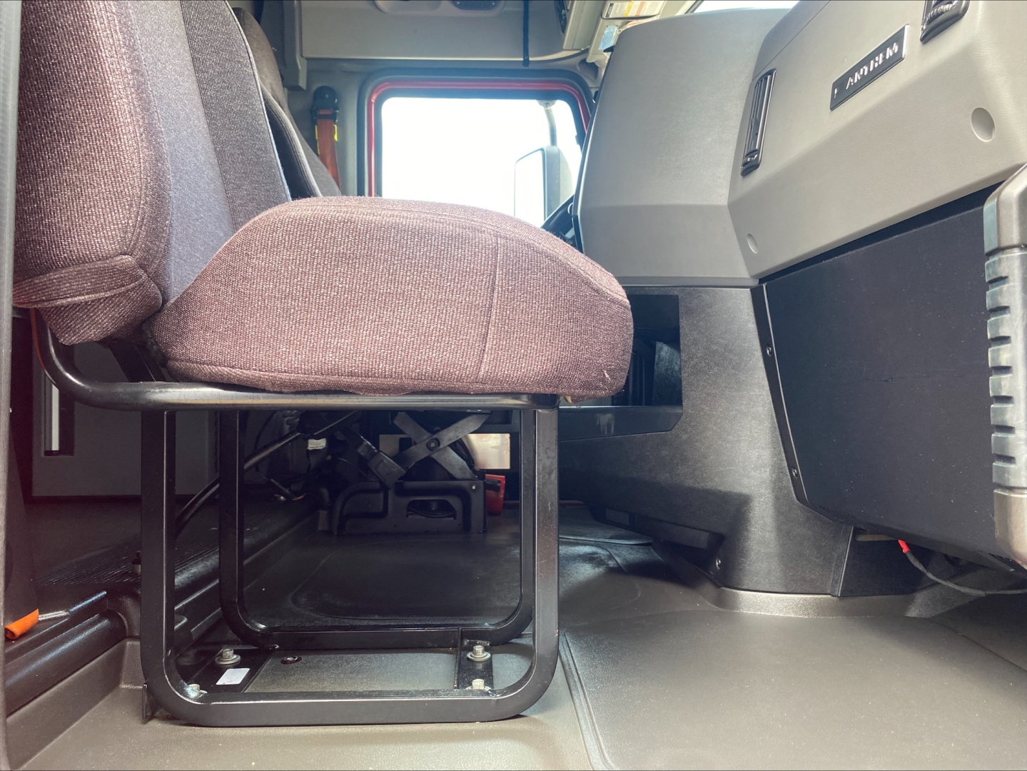 Interior view of a 2020 Mack AN64T70 truck cab showing driver's seat and dash area, with floor and pedal area visible.