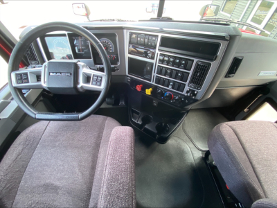 Mack AN64T70 truck dashboard and steering wheel with center console controls and gauges visible.