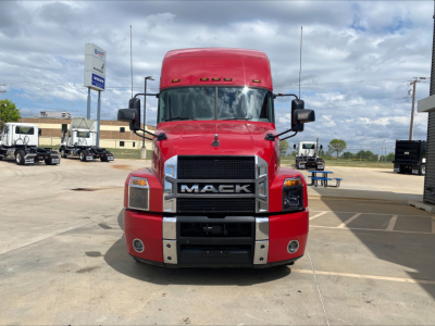 Truck front view of a red 2020 Mack AN64T70 conventional sleeper showing bold grille, headlights, and bumper.