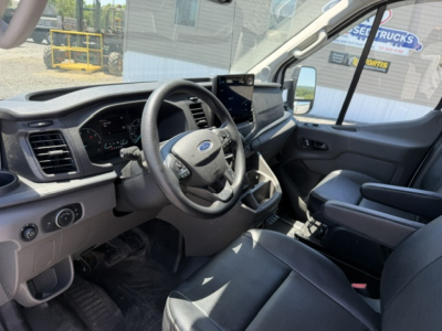 Ford Transit 350HD interior showing steering wheel, dashboard, and front seats.