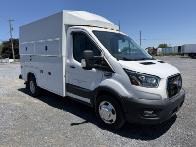 Ford Transit 350HD service utility van with utility box body, side compartments, and dual rear wheels, front three-quarter view.