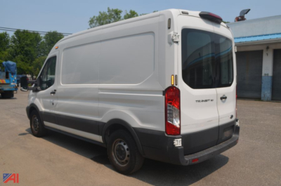 Ford Transit cargo van rear-right view showing closed side panels and taillights.